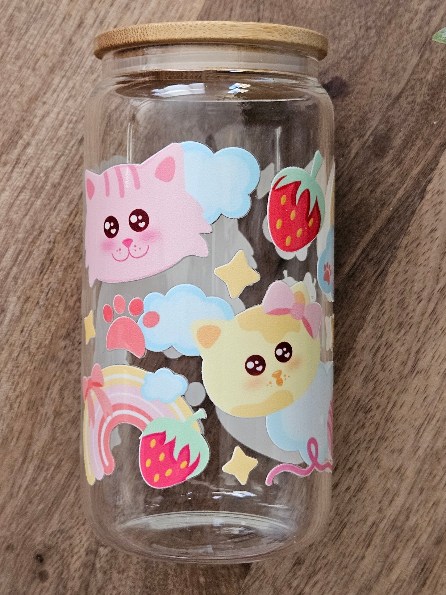 Sip your favorite drink in style with our Cat Rainbows Glass Cup! This adorable cup features a fun cat faces and is accented with a colorful rainbow design. Made of durable glass, it's both cute and functional. Perfect for any cat lover! Holds 16 oz , Hand wash only. Lid and Straw included
