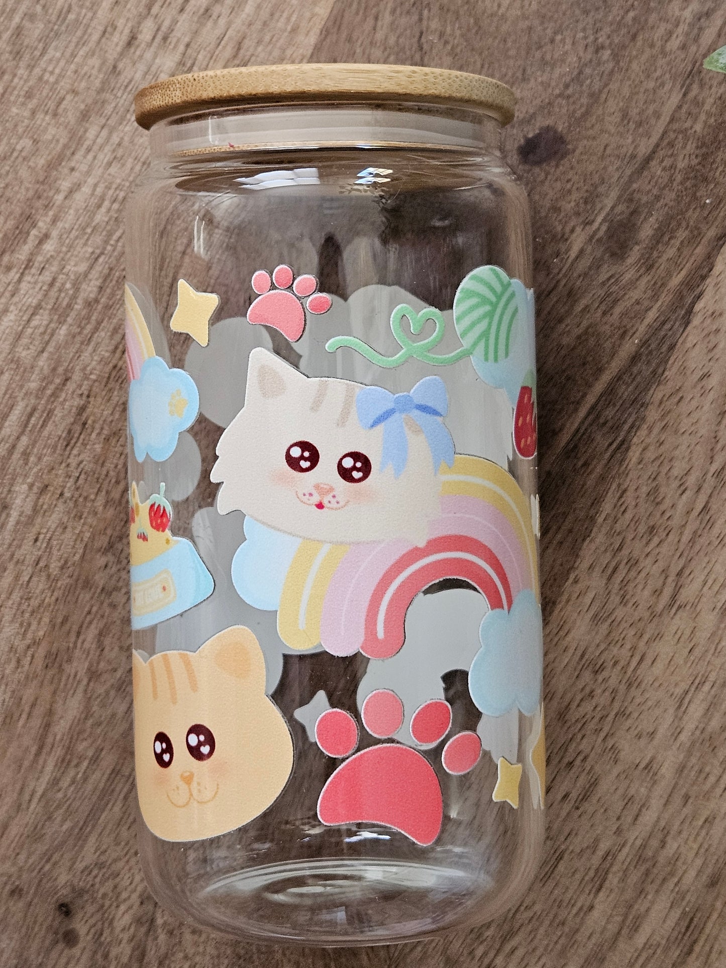 Sip your favorite drink in style with our Cat Rainbows Glass Cup! This adorable cup features a fun cat faces and is accented with a colorful rainbow design. Made of durable glass, it's both cute and functional. Perfect for any cat lover! Holds 16 oz , Hand wash only. Lid and Straw included